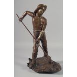 J DALBREUSE A BRONZE SCULPTURE OF A MAN WITH A SHRIMPING NET standing on a rustic base. Signed 16ins