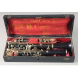 A CLARINET IN A FITTED LEATHER CASE. Case 14ins long.
