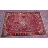 A PERSIAN CARPET, red ground with all over stylised decoration. 6'5" X 4'5"