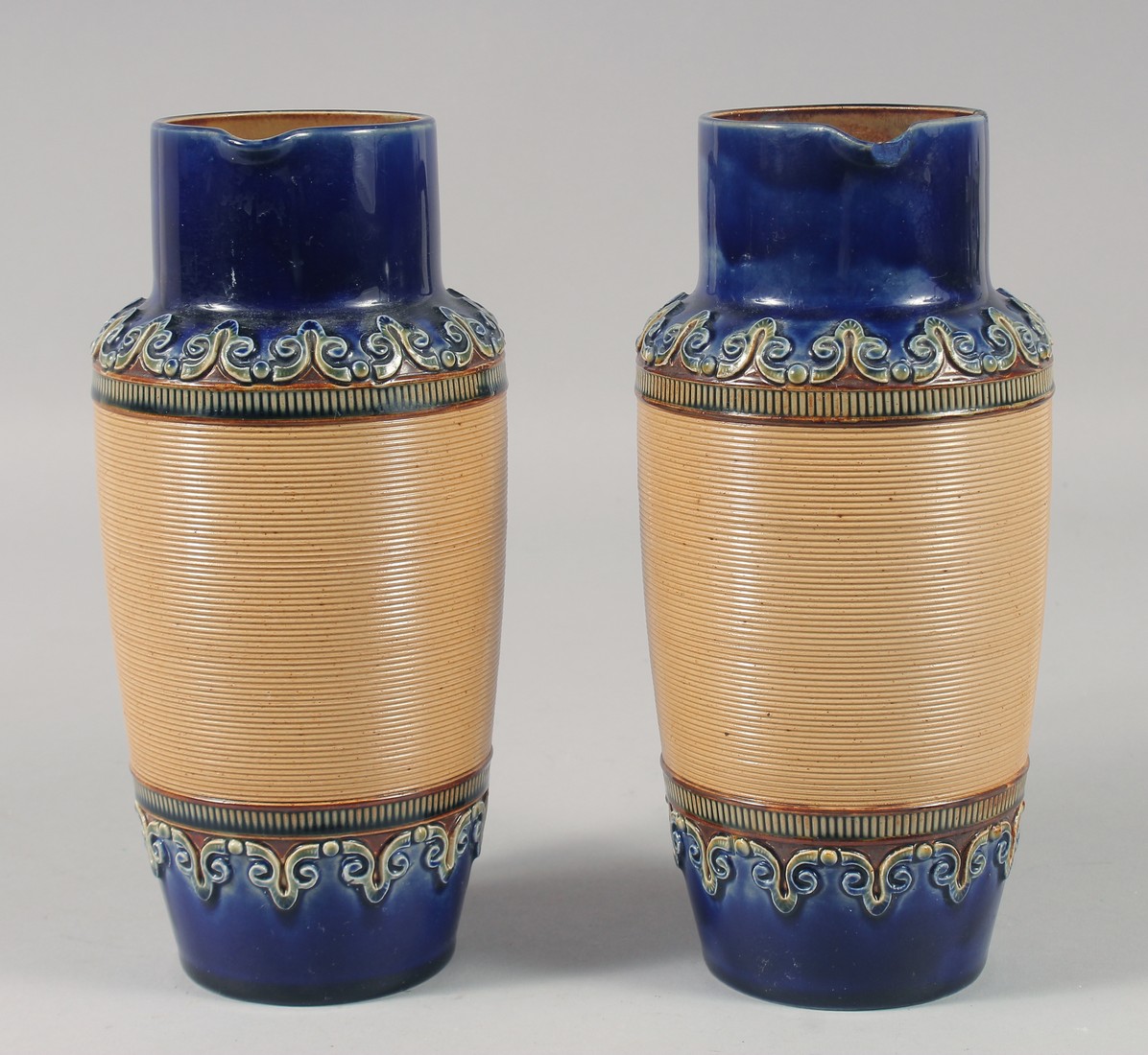 A PAIR OF ROYAL DOULTON STONEWARE JUGS with blue bands. 8ins high. - Image 4 of 6