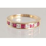 AN 18CT RUBY AND DIAMOND HALF ETERNITY RING.