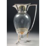 A CHRISTOPHER DRESSER STYLE CLARET JUG, on three curving legs. 10" high