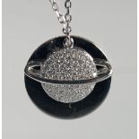 A SILVER PLANET PENDANT AND CHAIN.