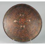 A FINE EARLY 19TH CENTURY NORTH INDIAN MUGHAL LACQUERED AND PAINTED LEATHER SHIELD, with embossed