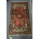 A SMALL PERSIAN WOOLLEN RUG with stylised decoration. 3'8" x 2'2"