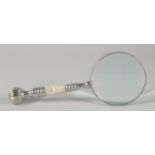 A MAGNIFYING GLASS with chrome and mother of pearl handle.