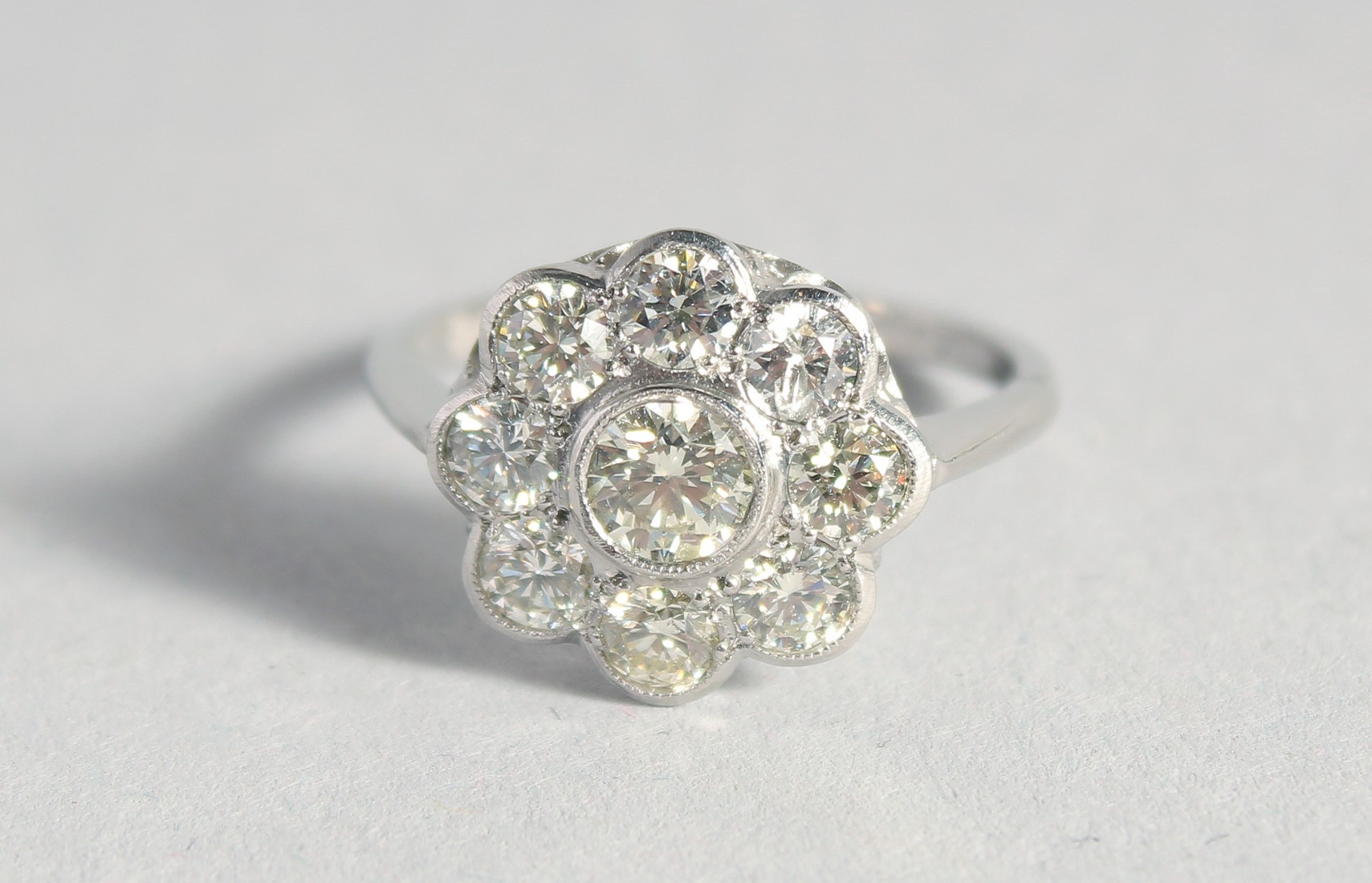 A SUPERB PLATINUM AND DIAMOND CLUSTER RING.