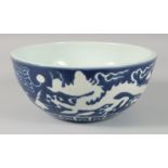 A LARGE CHINESE SACRIFICIAL BLUE DRAGON BOWL, the exterior with carved white dragons and clouds, the