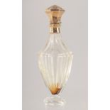 A CUT GLASS SCENT BOTTLE WITH HINGED GOLD TOP. 10cm high