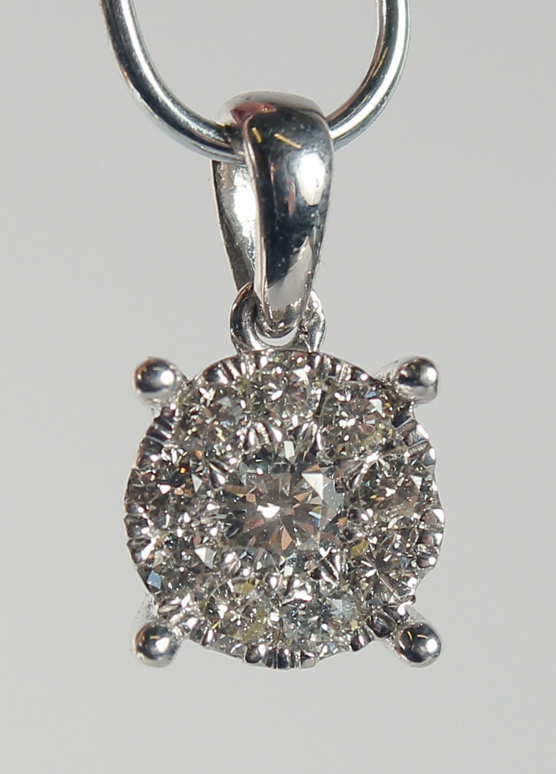 A 9ct. GOLD DIAMOND SET PENDANT.