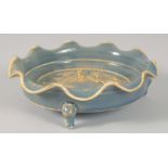 A CHINESE PETAL FORM RIM CELADON BOWL, with relief figural decoration to the interior and raised