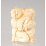 A CHINESE CARVED BONE EROTIC NETSUKE. 4.5cm.