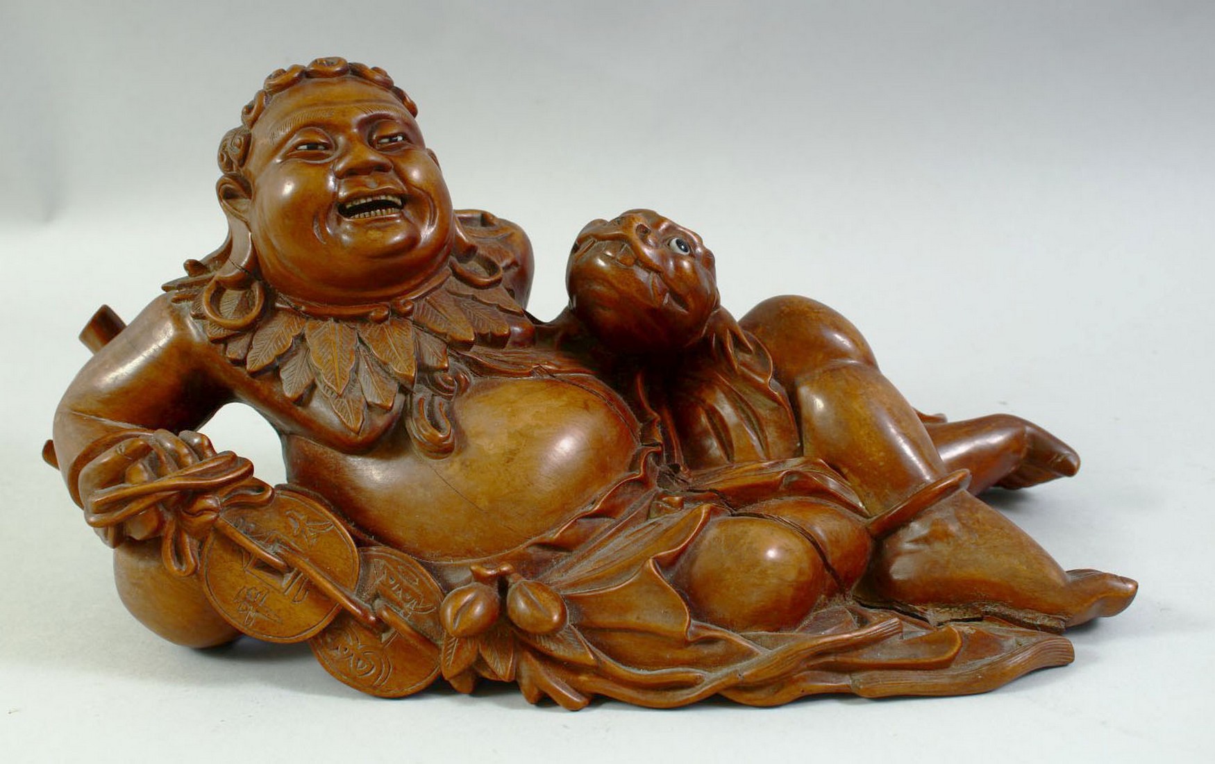 A LARGE CARVED HARDWOOD HOTEI, on a fitted carved hardwood stand, the figure reclining with a - Image 7 of 7