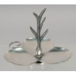 A SILVER COLOUR SHAPED RING STAND.