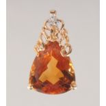 AN 18CT GOLD TOPAZ AND DIAMOND PENDANT.