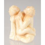 A CHINESE CARVED BONE EROTIC NETSUKE. 4.5cm.