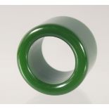 A DARK GREEN JADE ARCHERS RING. 3.5cm diameter.