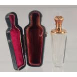 A CUT GLASS SCENT BOTTLE WITH HINGED GOLD TOP, cased. 9cm high