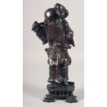 A CHINESE CARVED ROOTWOOD FIGURE of an immortal, mounted to a hardwood base, 33.5cm high.