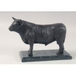 A BRONZE MODEL OF A STANDING BULL on a marble base. 10ins long.