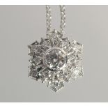 A PLATINUM AND DIAMOND SNOWFLAKE CLUSTER PENDANT. on 18ct gold chain.