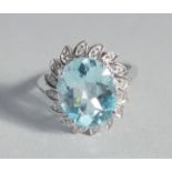 A SILVER AND BLUE TOPAZ AND DIAMOND RING.