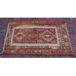 A KELIM RUG, beige and red ground with geometric decoration. 5'7" x 3'5"