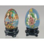 TWO CLOISONNE EGGS on a stand.