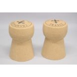 A PAIR OF NOVELTY BAR STOOLS modelled as champagne corks. 1ft 8 ins high.