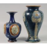 TWO ROYAL DOULTON BLUE FLORAL STONEWARE VASES. 10ins & 8ins high.