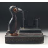 A 1920'S ART DECO BIRD CALENDER STAND WITH CHERRY AMBER / BAKELITE BEAK.