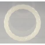 A CHINESE OPAQUE JADE TWISTED BANGLE. 8cm diameter