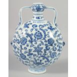 A CHINESE BLUE AND WHITE PORCELAIN TWIN HANDLE MOON FLASK, (damage to one handle), 29cm high.