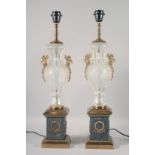 A PAIR OF EMPIRE STYLE CUT GLASS URN SHAPED LAMPS on bronze and marble bases. 25ins high.