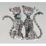 A SILVER MARCASITE RUBY SET CAT BROOCH.