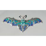 A SILVER ENAMEL AND RUBY EYE BAT BROOCH.