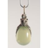 A SILVER AND JADE EGG SHAPED PENDANT, modelled as an owl. 2.5cm high