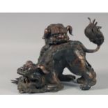 A CHINESE CAST BRONZED CENSOR modelled as two playful foo dogs. 11ins high.