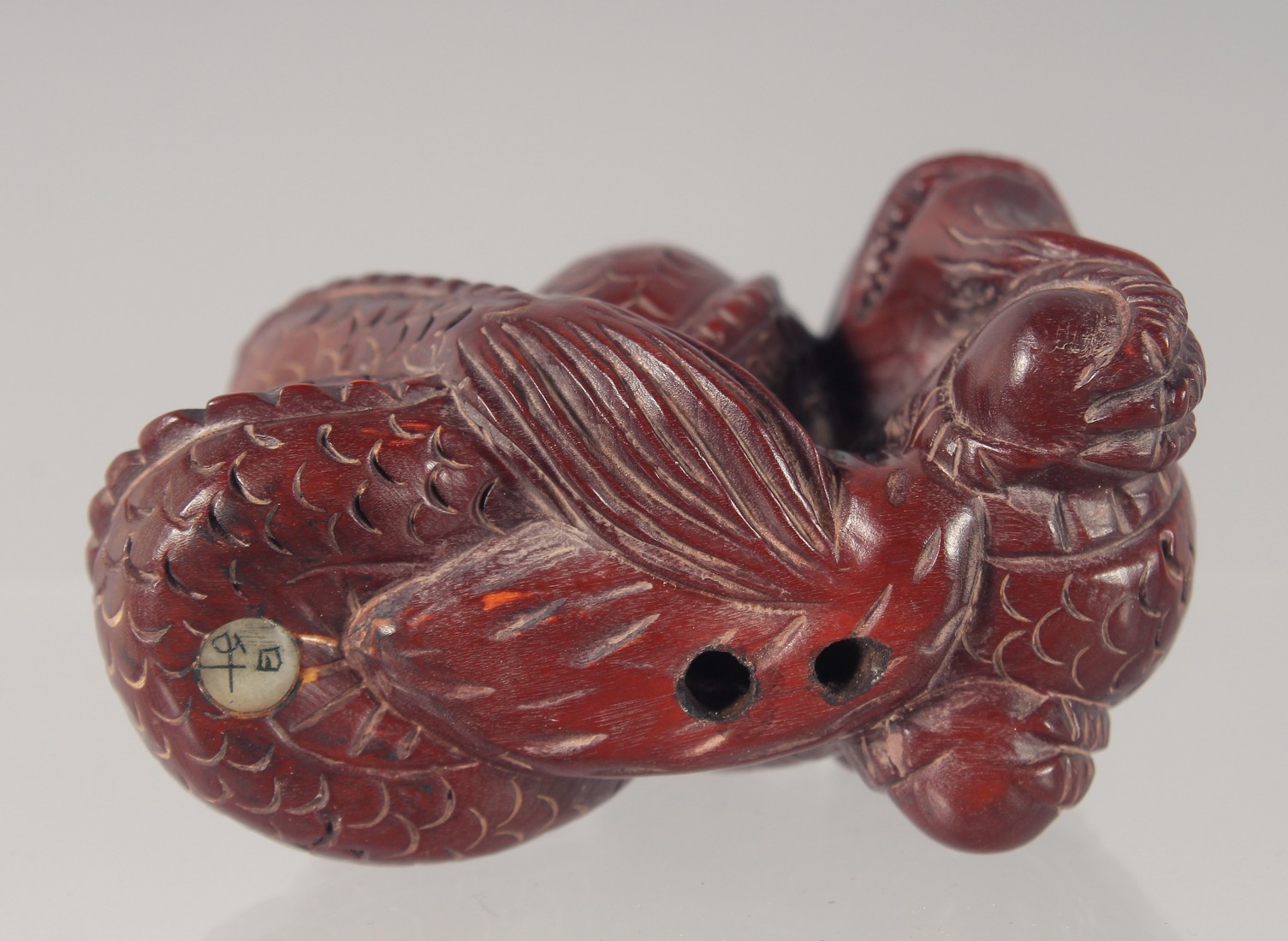 A CARVED WOOD NETSUKE modelled as a dragon 5.5cm long. - Image 4 of 4