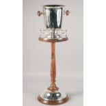 A PLATED AND WOOD ICE BUCKET ON MATCHING STAND. 30.5" high