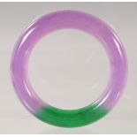 A CHINESE LAVENDER AND GREEN JADE BANGLE 8.5cm diameter.