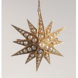A 15CT GOLD AND PEARL STAR SHAPED BROOCH. 3.5cm diameter