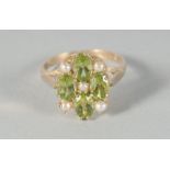 A 9ct. GOLD PERIDOT AND PEARL RING.