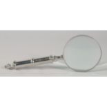 A MAGNIFYING GLASS with chrome handle.