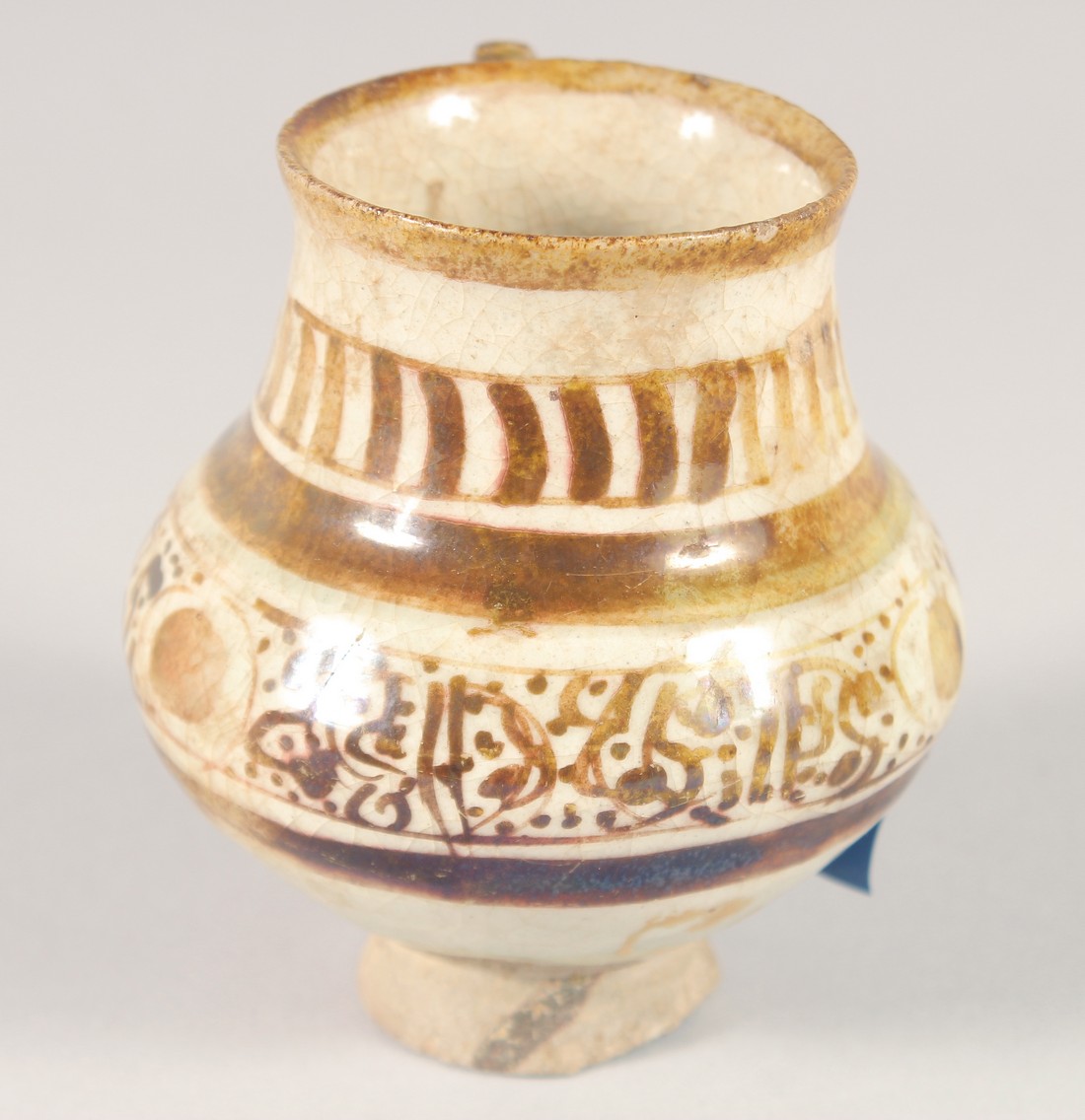 A SMALL KASHAN LUSTRE GLAZE POTTERY EWER, with provenance sticker; Christie's, 9cm high. - Image 4 of 7