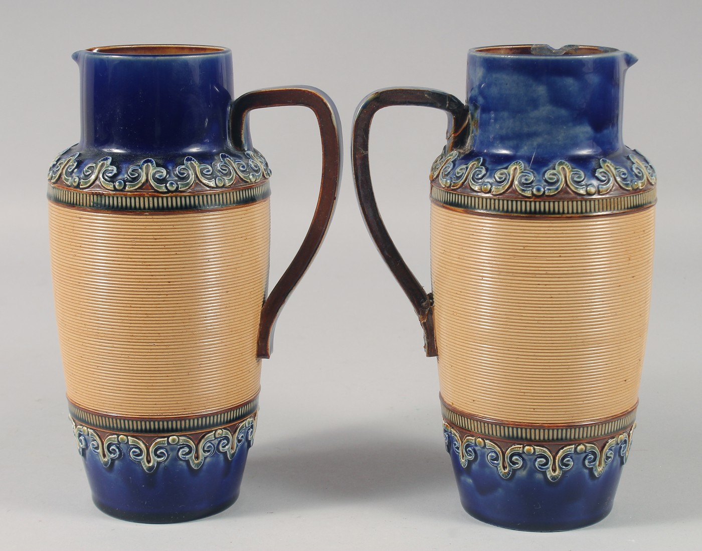 A PAIR OF ROYAL DOULTON STONEWARE JUGS with blue bands. 8ins high. - Image 3 of 6