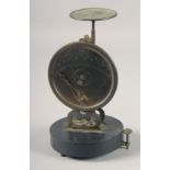 A RARE SET OF EARLY POSTAL SCALES on a circular base. 7ins high.