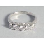 A SILVER CUBIC ZIRCONIA FIVE STONE RING.