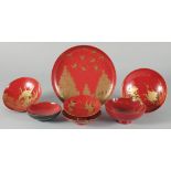 A COLLECTION OF SEVEN JAPANESE RED LACQUER DISHES, four pieces with gilt decoration depicting