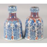 A PAIR OF 18TH CENTURY CHINESE IMARI DECANTERS, KANGXI PERIOD, painted with floral columns and